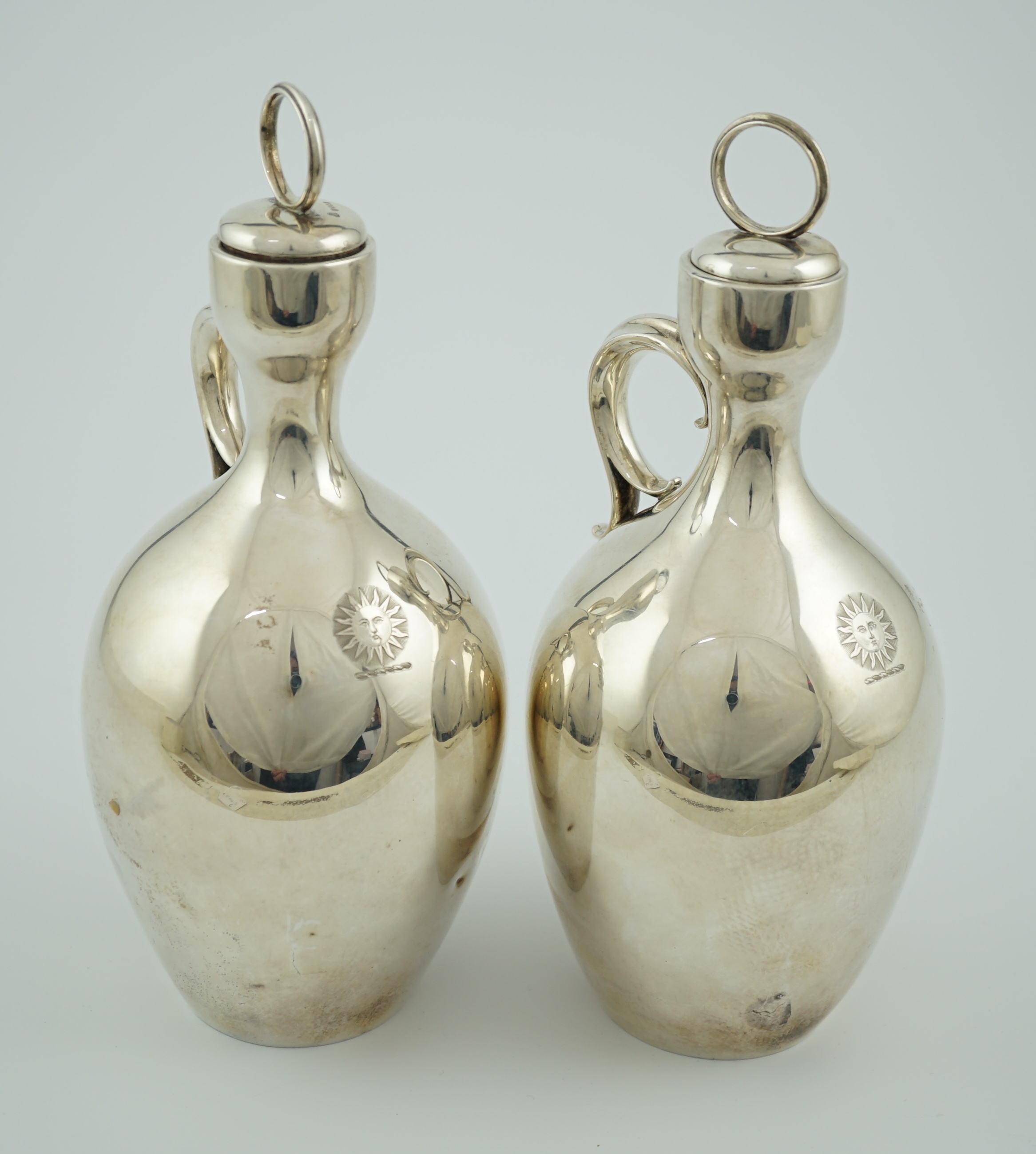 A pair of Victorian silver single handled ovoid water/wine jugs with stoppers, by R & S Garrard & Co